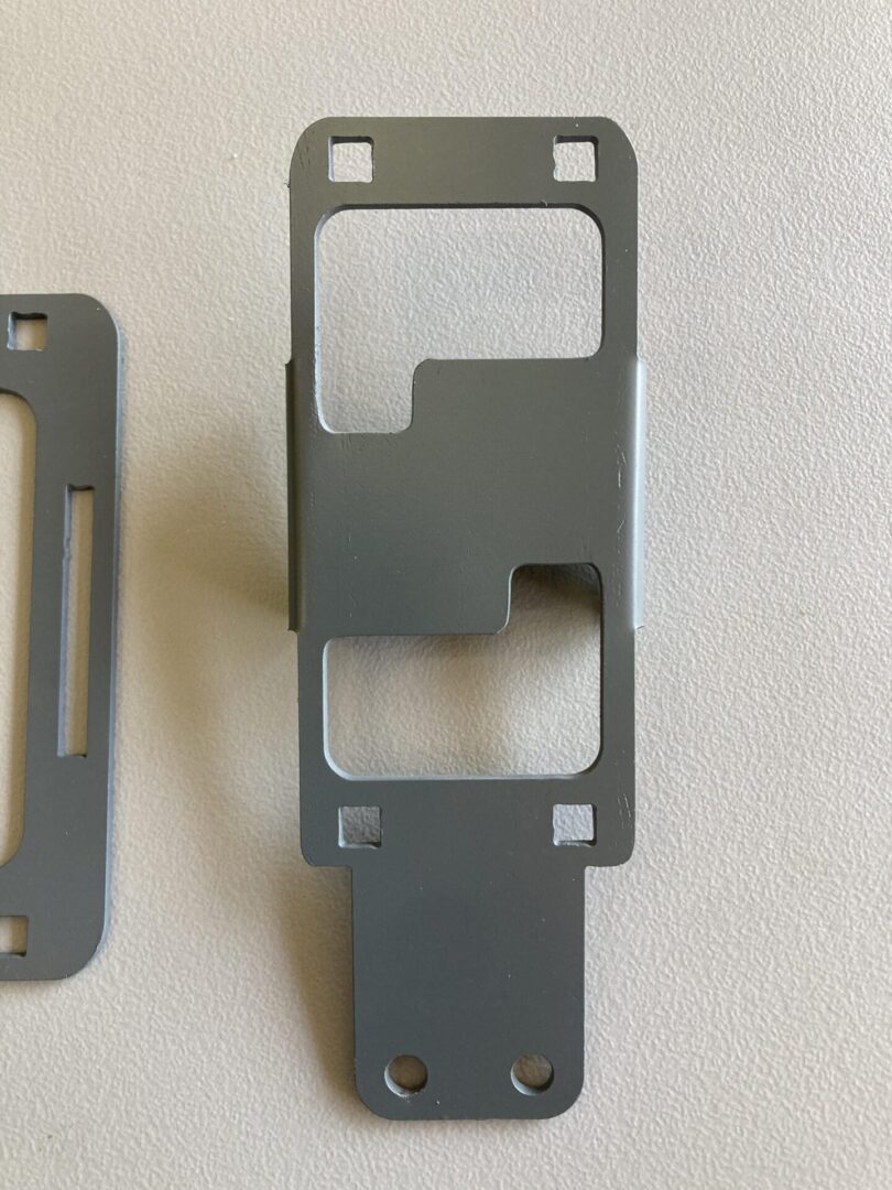 Two Phone Mounts on a white surface.